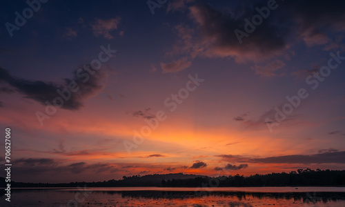 Dusk  Sunset sky clouds in the evening on twilight after sundown over silhouette mountain and lake water reflection with orange sunlight in Golden hour  Horizon sky landscape background  