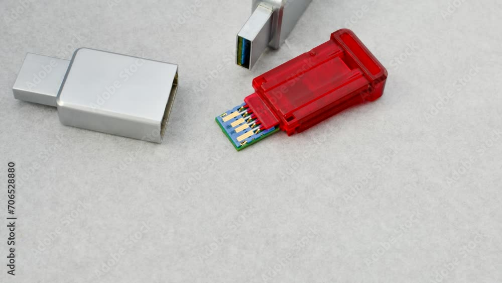 Close-up of a disassembled USB flash drive on a white background, revealing its internal complexity. Close-up of an open USB flash drive, exposing circuits and connections, on a white surface. Close-up of a disassembled USB flash drive on a white background, revealing its internal complexity. Close-up of an open USB flash drive, exposing circuits and connections, on a white surface.