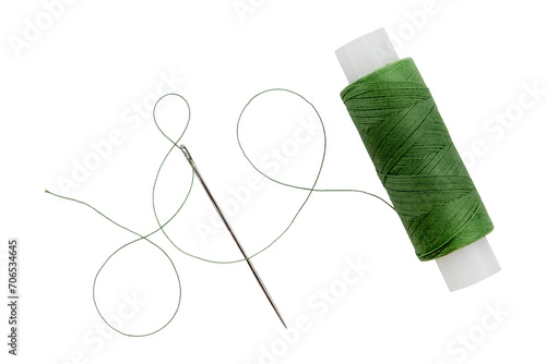 Old spool of thread and needle on a white background. Sewing accessories photo
