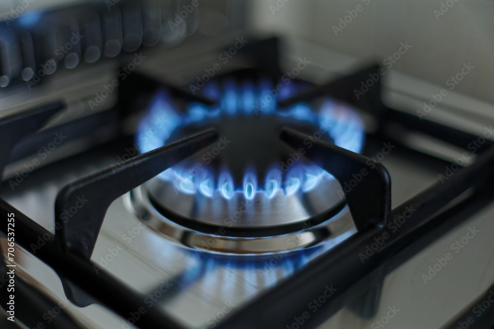 kitchen gas stove alight with flame coming out of it. Conceptual photo for gas, cost of bills, rising prices, heat and the environment. metal Ukraine, Russia, Europe. blu flame. united states. cook kitchen gas stove alight with flame coming out of it. Conceptual photo for gas, cost of bills, rising prices, heat and the environment. metal Ukraine, Russia, Europe. blu flame. united states. cook