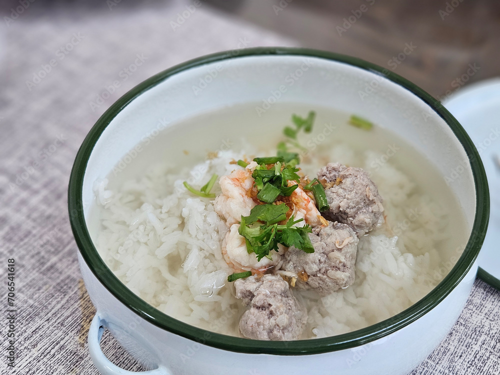 Shrimp and ground pork boiled rice with clear soup on white bowl