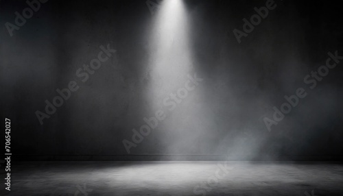 Spotlight illuminates a smoky  empty dark room  creating a dramatic and moody atmosphere.