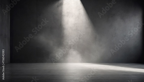 Spotlight illuminates a smoky, empty dark room, creating a dramatic and moody atmosphere.