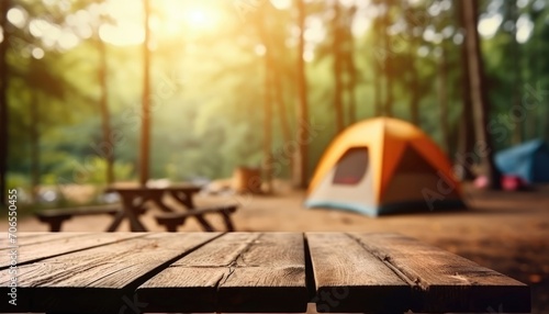 Blurred camping and tents in forest Wood table. photo