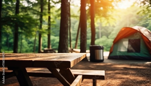 Blurred camping and tents in forest Wood table.