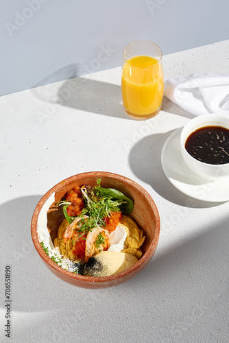 Scrambled omelet with shrimps and cheese mousse, complemented by coffee and orange juice, offering a balanced breakfast