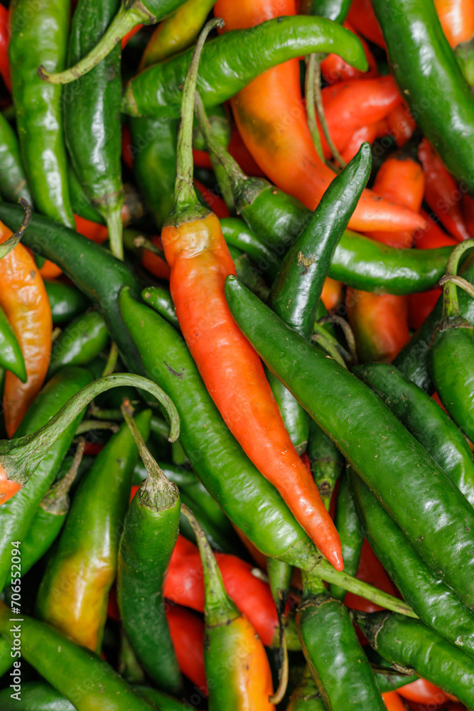 Green and red chili pappers. Selective focus. Vertical mode. Green and red chili pappers. Selective focus. Vertical mode.