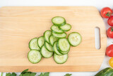 Top view of ripe cucumber cut into slices for vegetable salad.