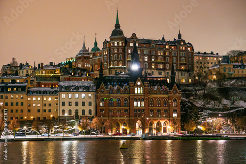 Stockholm  district of Sodermalm at night in winter with snow on the ground  historic buildings. Cloudy sky  lake reflections.
