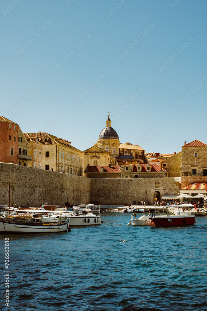 Amazing view of Dubrovnik old city and the boats in a marina on a sunny day. Travel destination in Croatia.