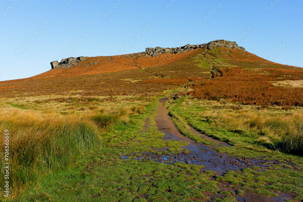 Muddy footpath leads up a steep slope to the top of Higger Tor