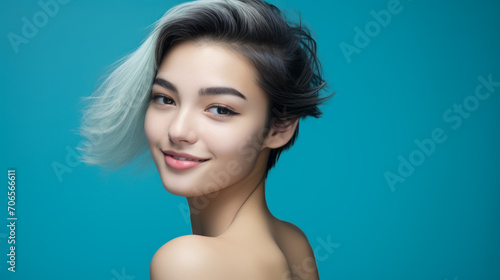 Charming young asian woman with stylish hair on blue