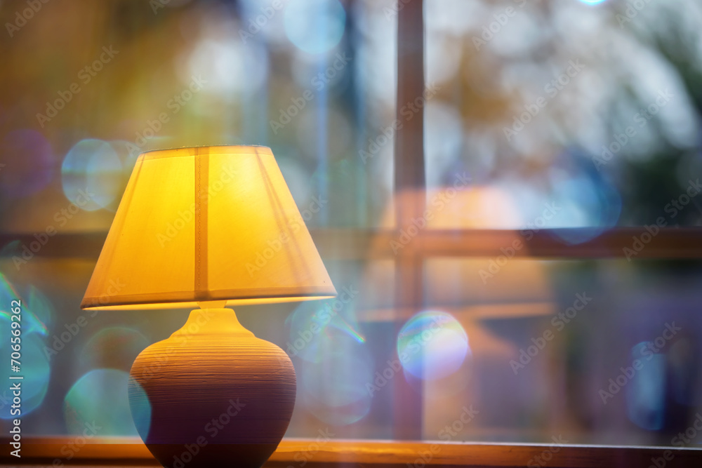 Yellow cozy lamp on a blue bokeh background. Yellow cozy lamp on a blue bokeh background.