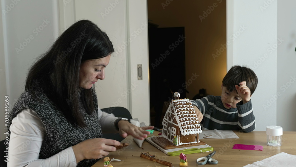 Mother and Child Creating Gingerbread House, traditional Home December Festivities