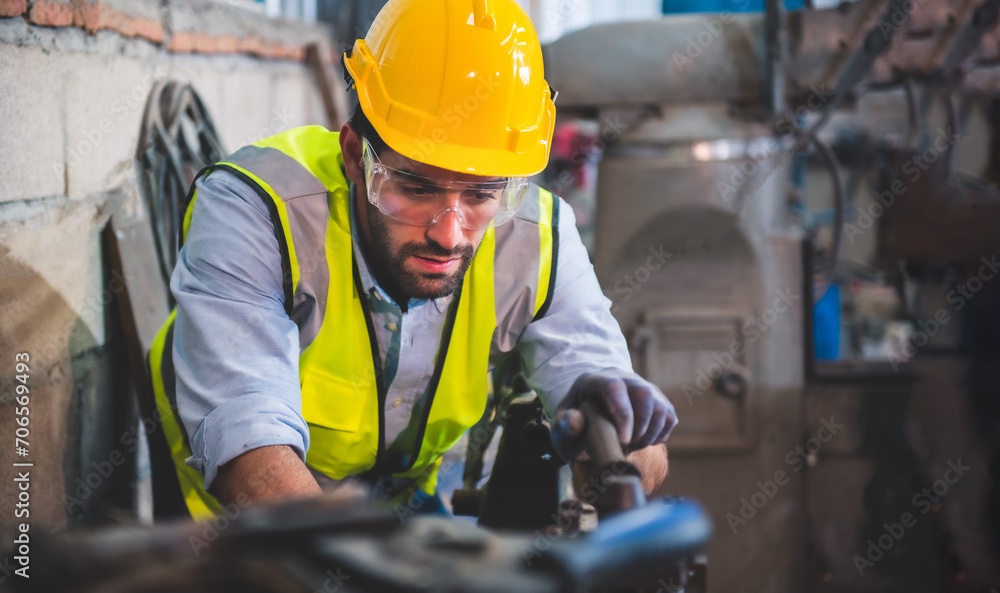 Portrait of Heavy industry workers working on the metal fabrication process by operating a lathe at a machine for steel structure industry. Portrait of Heavy industry workers working on the metal fabrication process by operating a lathe at a machine for steel structure industry.
