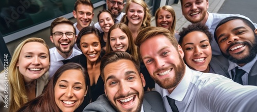 Office employees take a group selfie  showing their smiles and teamwork. Company diversity  business collaboration  and staff happiness. Professional workplace  united for success.