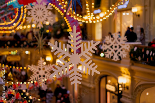 Christmas illumination and decoration with Snowflakes, golden lights bokeh, city shopping mall