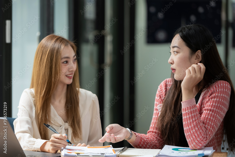 Two business colleagues talking share ideas and express their opinions while working together. Two business colleagues talking share ideas and express their opinions while working together.