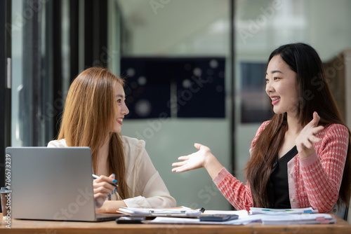 Two business colleagues talking share ideas and express their opinions while working together.