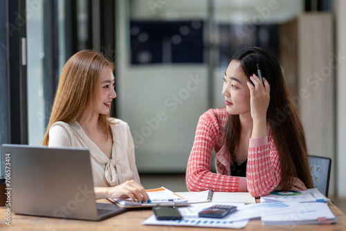 Two business colleagues talking share ideas and express their opinions while working together.