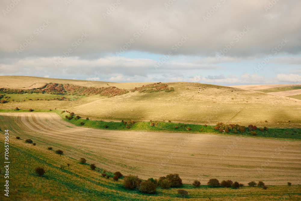 Rolling hills in the South Downs at sunset with patchy clouds, England, UK