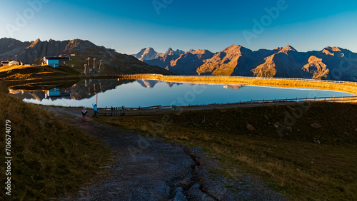 Alpine summer sunrise view with reflections in a lake at Mount Sechszeiger, Pitztal valley, Jerzens, Imst, Tyrol, Austria