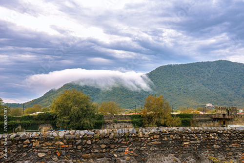 White cloud lies on the mountain. View of the mountains from the territory of the Kindzmaraulli wine factory in the city of Kvareli, Kakheti region, Georgia.