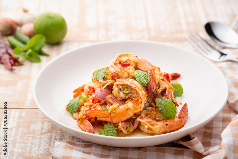 Spicy salad with shrimp.Thai style prawn salad with lemongrass shallot mint mixed with Chili Paste and lime sauce (pla goong) Spicy salad with shrimp.Thai style prawn salad with lemongrass shallot mint mixed with Chili Paste and lime sauce (pla goong)