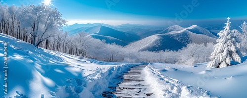 A view of the Bieszczady mountains in winter during the afternoon hours, captured from a hiking trail, showcasing the serene snow-covered landscape and the beauty of the natural surroundings