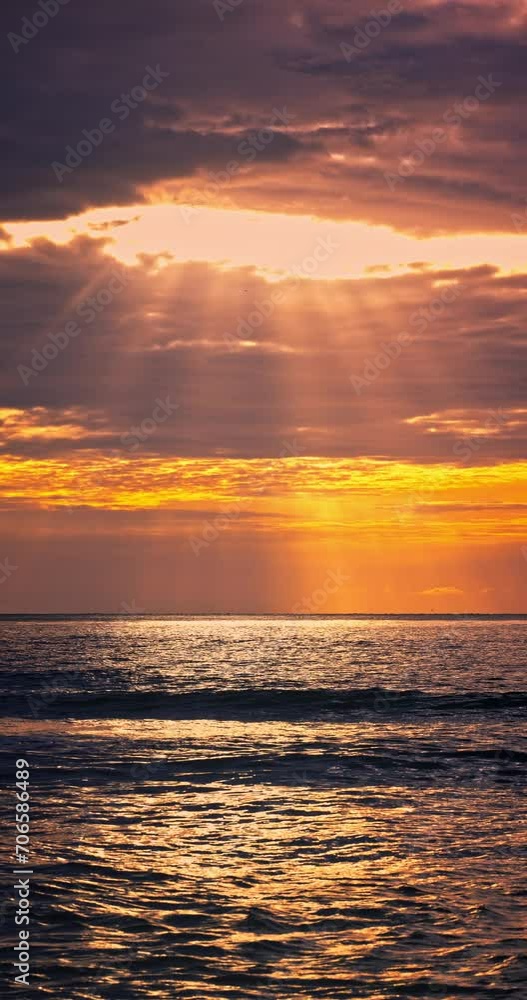 Tropical color cloudscape sunrise over calm sea waves and sun rays through the clouds vertical panorama 4k video Tropical color cloudscape sunrise over calm sea waves and sun rays through the clouds vertical panorama 4k video
