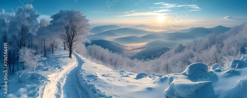 A view of the Bieszczady mountains in winter during the afternoon hours, captured from a hiking trail, showcasing the serene snow-covered landscape and the beauty of the natural surroundings © Tomasz