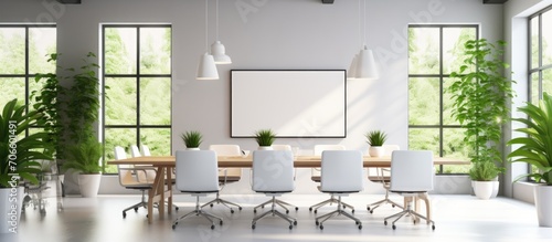 Modern minimalist office conference room with white table, comfortable chairs, whiteboard, shelves, indoor plants, and large windows.