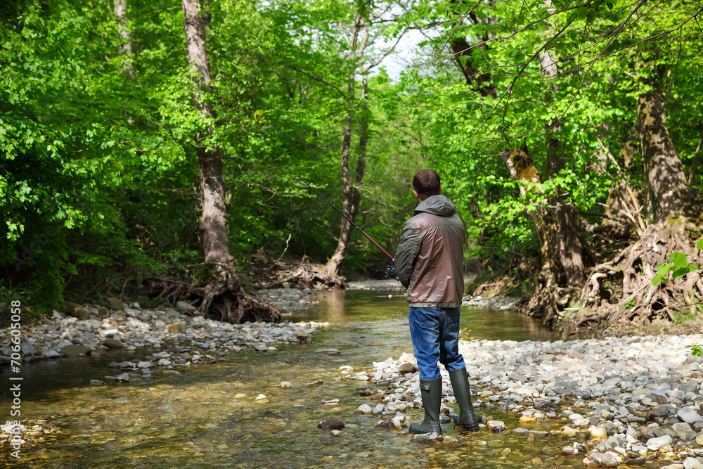 Fisherman with fly-fishing on mountain river Fisherman with fly-fishing on mountain river