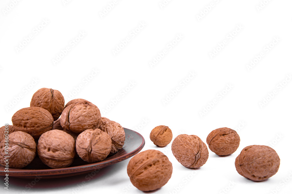 Walnuts are on a plate. Isolate. Ingredients. Diet and weight loss. Vitamins. Walnuts are on a plate. Isolate. Ingredients. Diet and weight loss. Vitamins.