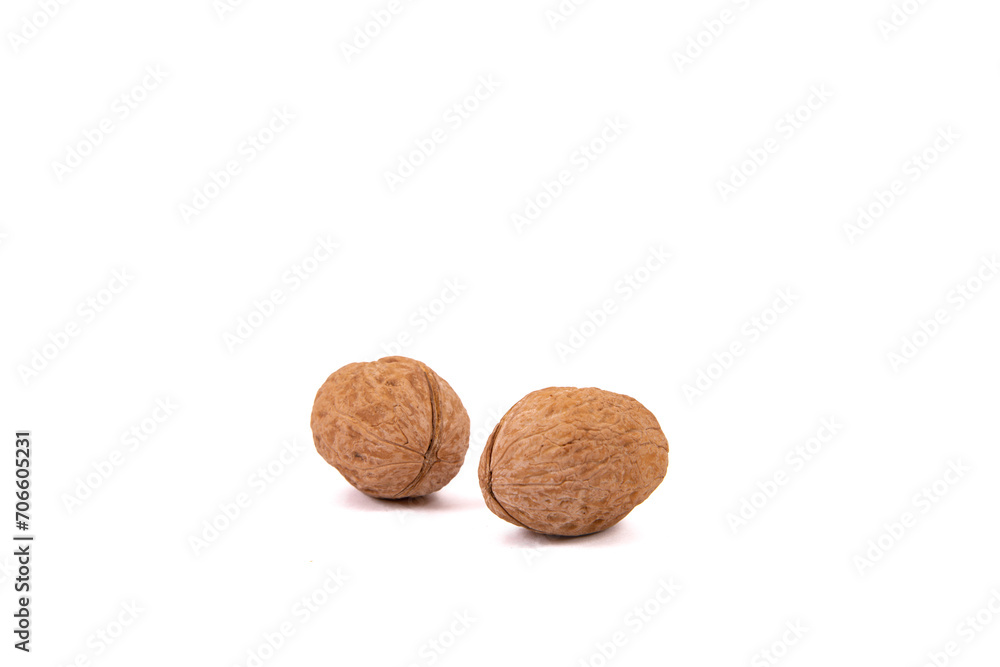 Scattered whole walnuts lie on a white background. Backgrounds and textures. Isolate. Scattered whole walnuts lie on a white background. Backgrounds and textures. Isolate.