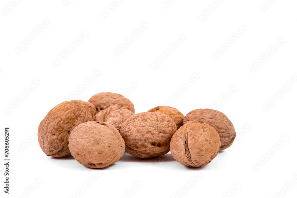 Scattered whole walnuts lie on a white background. Backgrounds and textures. Isolate. Scattered whole walnuts lie on a white background. Backgrounds and textures. Isolate.