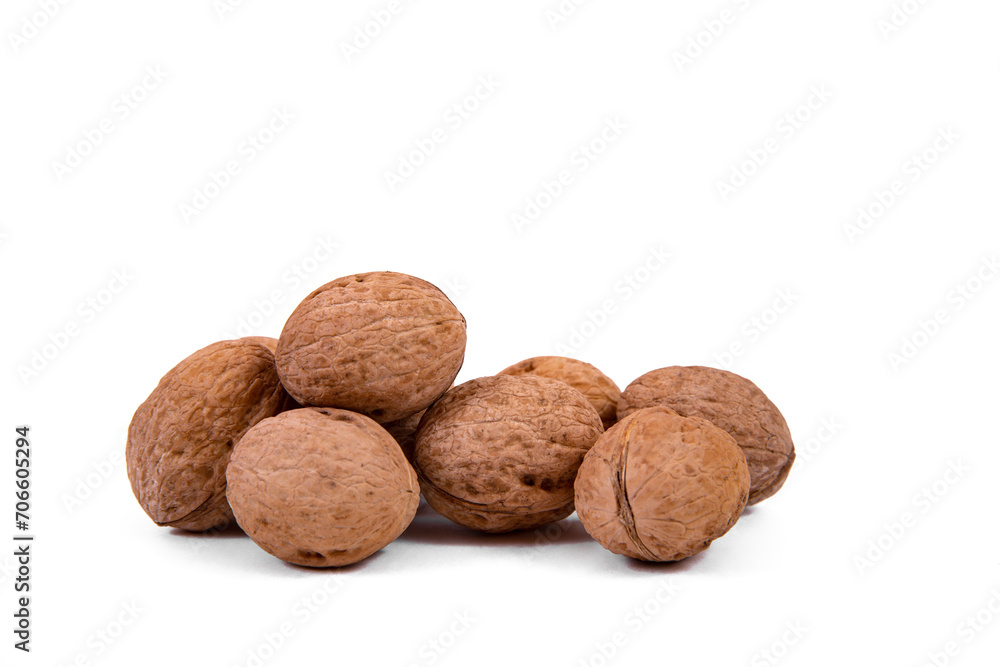 Scattered whole walnuts lie on a white background. Backgrounds and textures. Isolate. Scattered whole walnuts lie on a white background. Backgrounds and textures. Isolate.