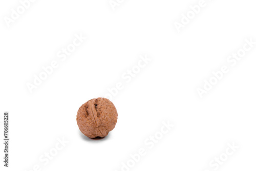 Scattered whole walnuts lie on a white background. Backgrounds and textures. Isolate.