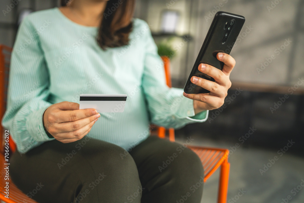 Pregnant woman doing online shopping hold credit card sit at home Pregnant woman doing online shopping hold credit card sit at home