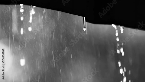 Rain falling from the roof in slow motion 4x. Climate change concept and increased rainfall. photo