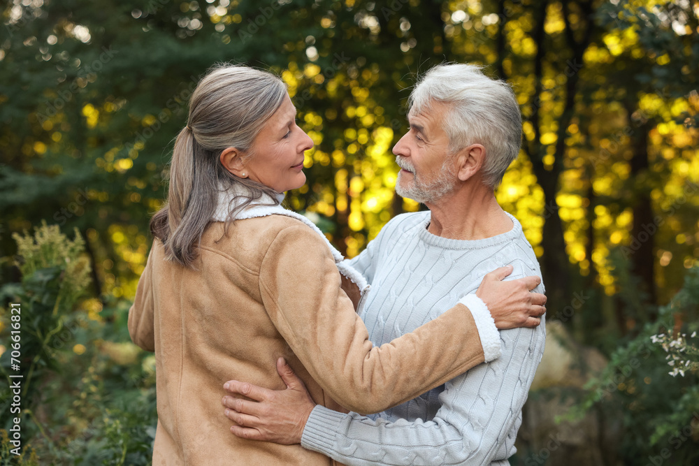 Affectionate senior couple dancing together outdoors. Romantic date