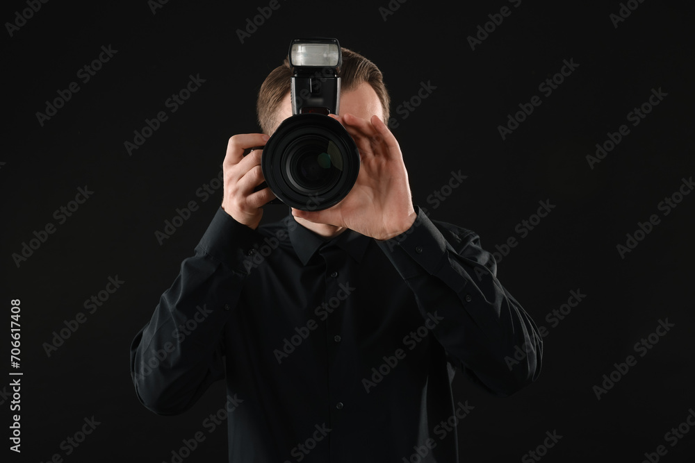 Professional photographer taking picture on black background Professional photographer taking picture on black background