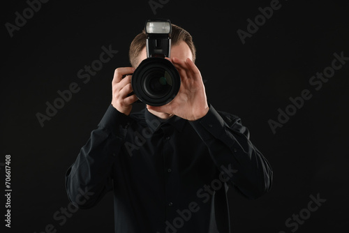Professional photographer taking picture on black background © New Africa