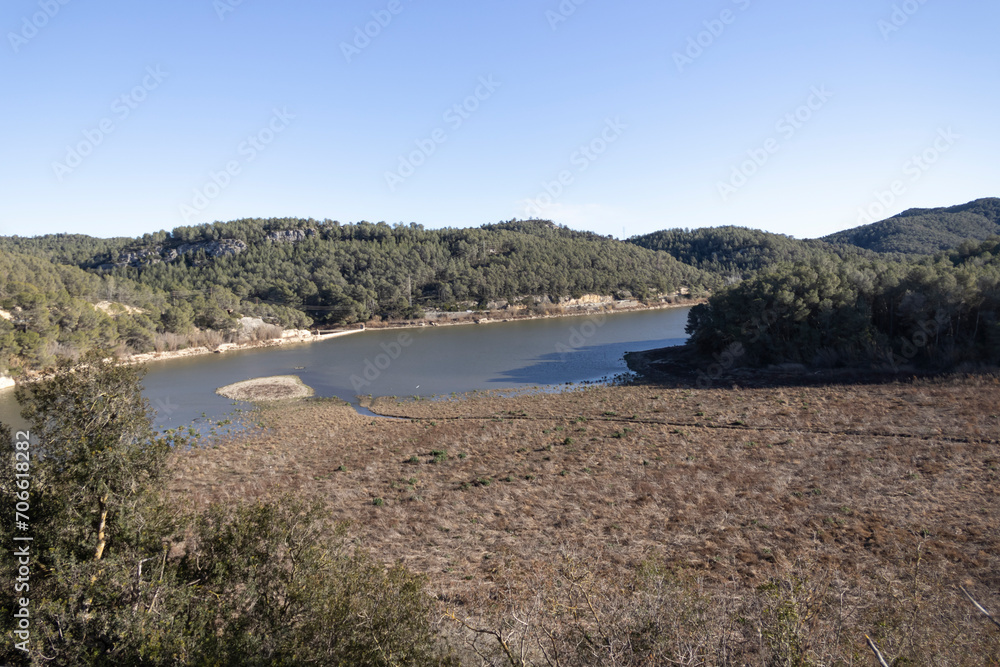 Views of the Foix reservoir, almost empty, half land, half water, due to the lack of rain as a consequence of climate change.