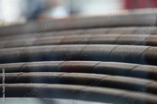A lot modern black plastic spiral hoses closeup. Helical polymer wire reinforced pipes