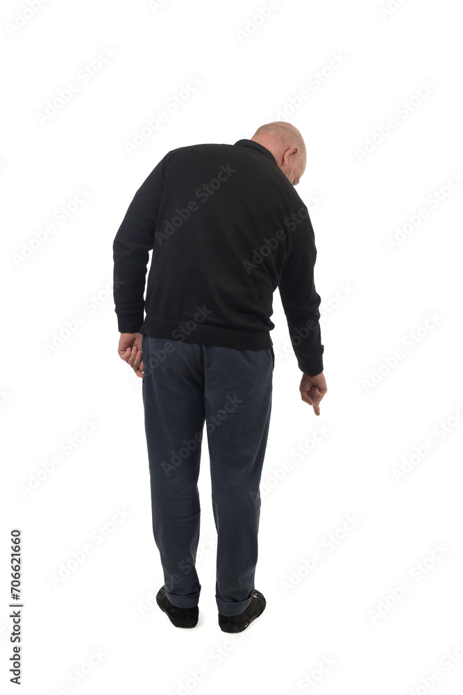Fototapeta premium back view of a man pointing finger at the ground isolated on white background