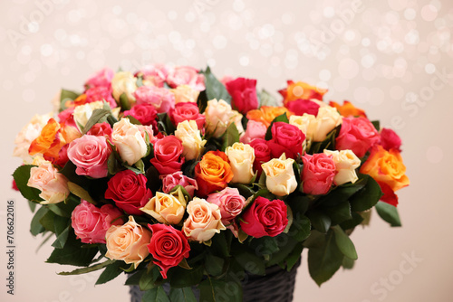 Bouquet of beautiful roses on beige background