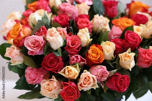 Bouquet of beautiful roses on light grey background, closeup