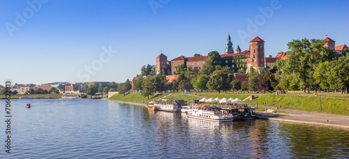Panorama over the Vistula river with ship and the Wawel castle in Krakow, Poland