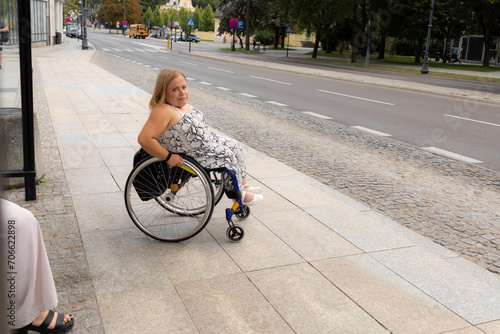 International Wheelchair Day. Person With Short Stature On Wheelchair Waiting For Public Transport On Bus Stop Outdoor. Female Adult With Disability. Copy Space For Text. Transportation. 